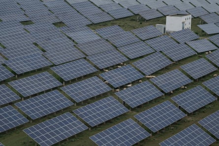 Solar panels stacked together in a field.