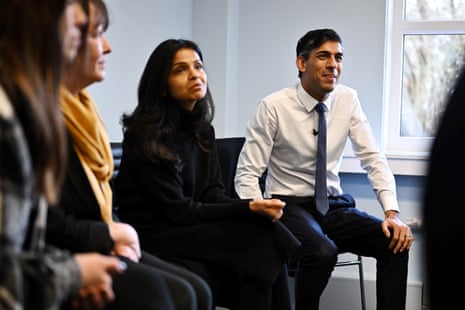 Rishi Sunak (R) with his wife Akshata Murty who also attended the visit to the St Austell family hub.