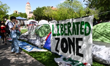 a banner reads 'liberated zone' on a college campus
