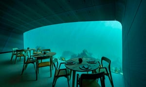 Wooden tables and chairs are by Hamran, a local designer, in Under restaurant, southern Norway
