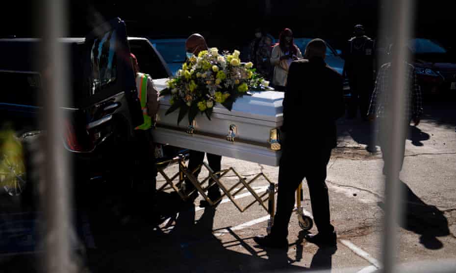 A casket is loaded into a hearse at the Boyd Funeral Home. Burials at cemeteries are delayed amid the surge of Covid-19 deaths in Los Angeles, California.