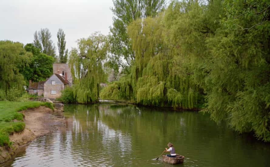 Documenting encounters and happenings ... druid Chris Parks rows his homemade coracle near Lechlade on the upper Thames.