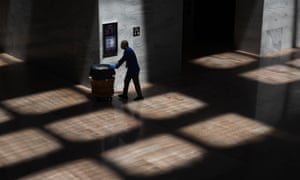 A custodian walks in the Senate office building on Capitol Hill in Washington DC Tuesday.