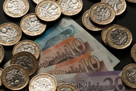 British banknotes and one-pound coins scattered