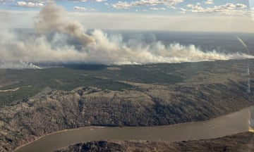 Large smoke on land with a river beneath