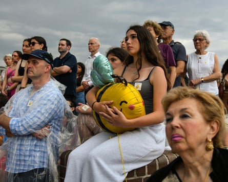 A young woman at Sunday’s event holds a bee balloon, symbolising 10-year-old Matilda, the youngest victim of last week’s attack.