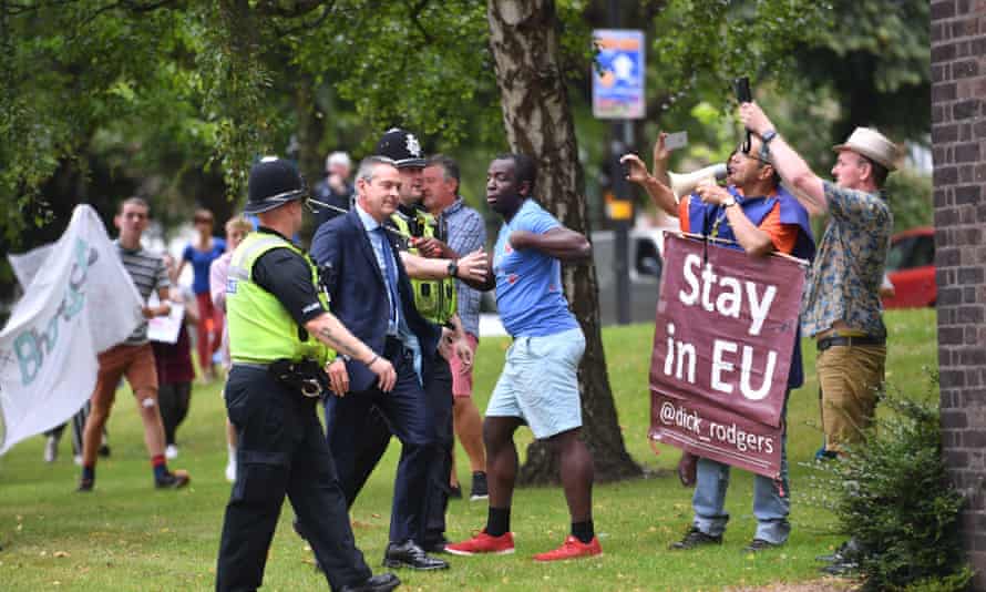 Police officers watch protesters as Boris Johnson arrives at West Midlands Police’s learning and development centre, Birmingham