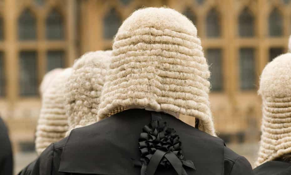 Rear view of judges in wigs outside Westminster Abbey