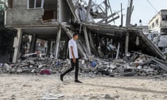 A man walk passes the rubbles of destroyed buildings after an Israeli airstrike in Rafah.