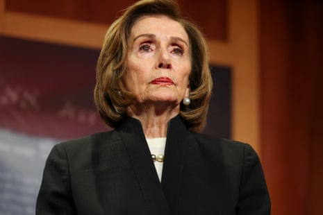 Nancy Pelosi, in a black blazer and pearl earrings