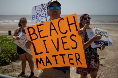 Local residents hold signs in protest of closed beaches on the 4th of July amid the global outbreak of coronavirus in Galveston, Texas, USA on 4 July, 2020.