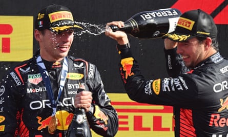 Max Verstappen gets doused with champagne by his teammate Sergio Pérez after the Italian Grand Prix