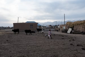 Girl carries bottles of water in Sary-Mogol.