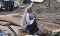 A woman sit amid the destruction after an Israeli airstrike killed at least 90 Palestinians in a designated humanitarian zone in Khan Younis.