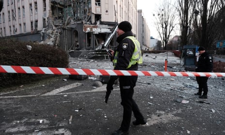 Ukrainian emergency personnel at the scene of a Russian missile attack on New Year’s Eve in Kyiv