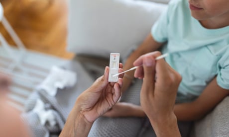 Mother is taking rapid covid-19 test at home to her sick daughter at home.