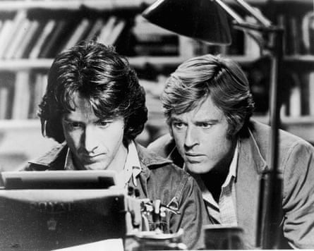 Men staring at typewriter