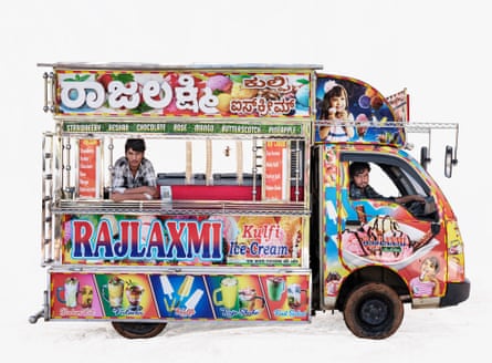 Ice-cream vendors Hariom and Vinoth in their Tata van in Bengaluru, India. The van is very brightly coloured with intricate paintings