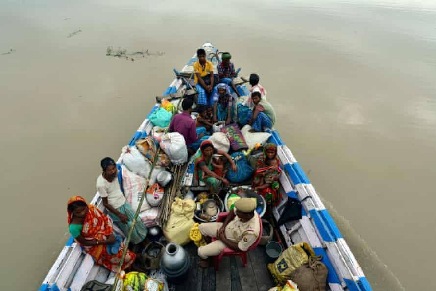 Flood affected villagers are shifted to a relief camp in a small boat in Morigaon district, Assam, India