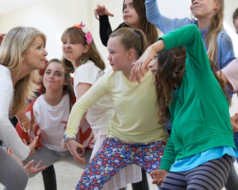 Group of children with teacher enjoying dancing