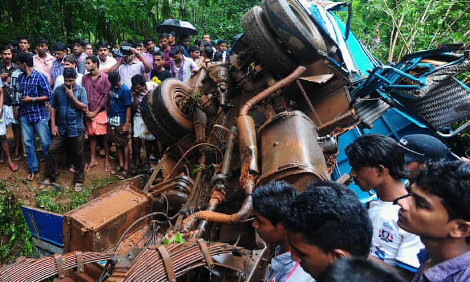 The tangled wreckage of a minibus is pictured as onlookers gather at an accident scene in Chelakkad, in the Malappuram district of India’s Kerala state