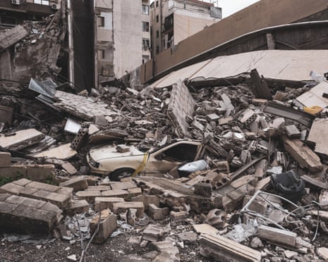 A car amid the ruins of a residential building near the centre of Beirut – near an area linked to Hezbollah – after repeated Israeli military strikes