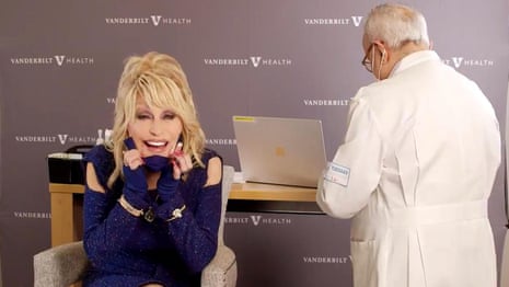 'Vaccine, vaccine': Dolly Parton adapts Jolene as she receives Covid-19 jab she helped fund – video