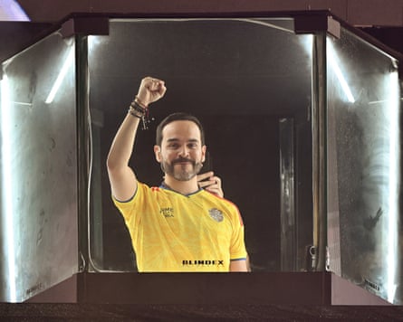 Abelardo de la Espriella, wearing a yellow football shirt, raises his fist in the air