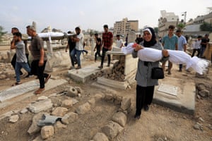 Woman carrying a body wrapped in a shroud