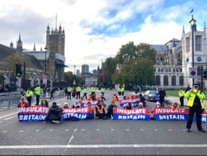 Insulate Britain campaigners outside the Houses of Parliament today.