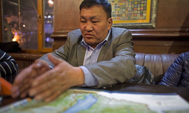 Tumursukh with a map of Mongolia’s national parks sits in a cafe near the environment ministry in the Mongolian capital, Ulaanbaatar.