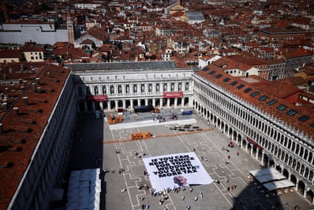 a banner in a square that says ‘if you can rent Venice for your wedding you can pay more tax.’