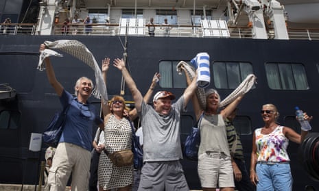 Excited passengers disembark from the MS Westerdam cruise ship after being stranded for two weeks.