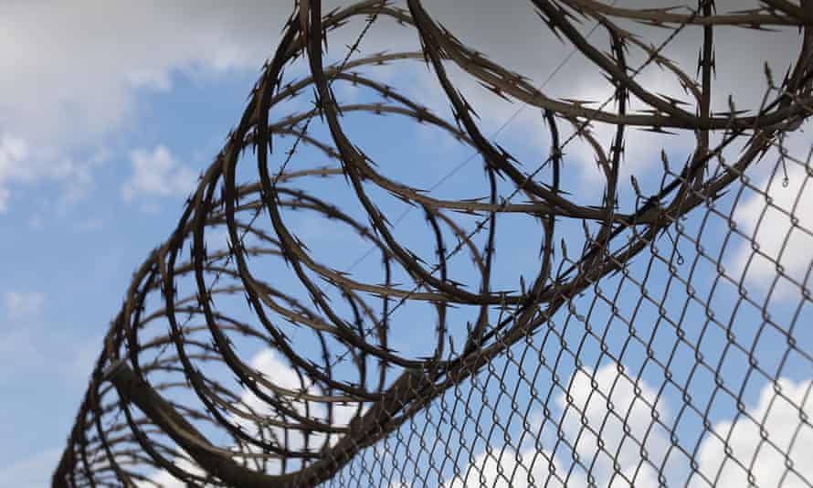 Barbed wire prison wall