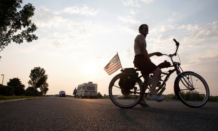 Michael Schmidt, an employee at IHOP restaurant for eight years, sits for a portrait on his bike on the street where he – and others – are living in their campers, in Bozeman, Montana.