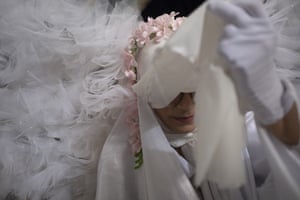 Closeup of the woman’s face, which is partially hidden by white veils