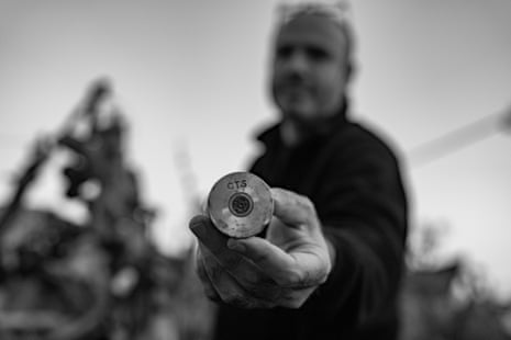 An Israeli activist demonstrates the canisters used by both army and settlers.