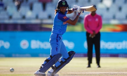 India's Harmanpreet Kaur clears the ball offside during her innings against Australia.