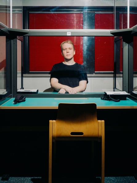 Aleksanteri Kivimäki, accused of hacking a popular Finnish therapy site and leaking thousands of patients’ intimate information, sitting at adesk in prison in February 2024