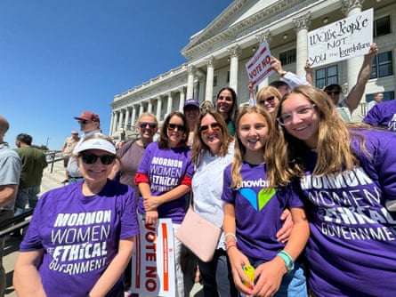 women wearing shirts that read ‘Mormon women for ethical government’ smile outside