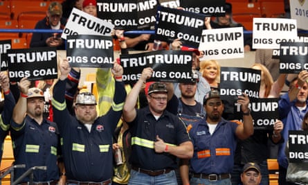 A group of coal miners wave signs for Republican presidential candidate Donald Trump as they wait for a rally in Charleston, West Virginia on Thursday.