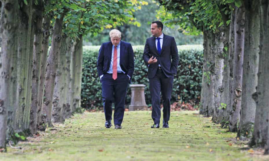 Leo Varadkar (R) and Boris Johnson go for a walk before their meeting.