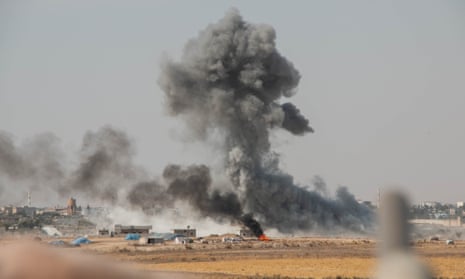 Smoke rises amid bombing of the Kurdish-held city of Ras al-Ayn by Turkish-supporting rebels.