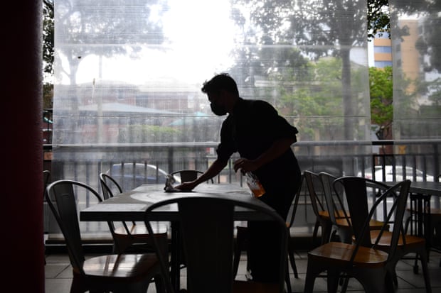 Workers clean tables for outdoor dining