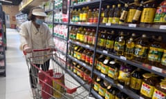 A person shops for cooking oil in Beijing.