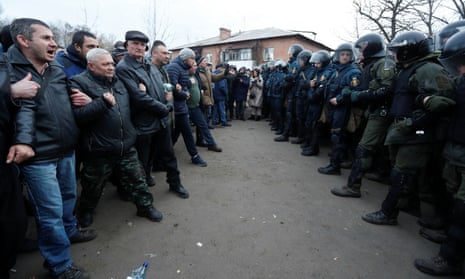Demonstrators  in Novi Sanzhary, Ukraine, confront law enforcement officers as they protest the arrival of evacuees from Covid-19-hit China.