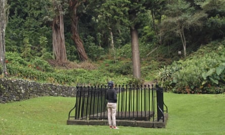 A woman looking at an unmarked grave