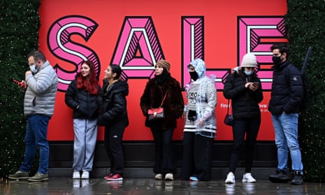People queue up outside Selfridges for Boxing Day sales on Oxford Street in London