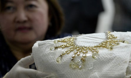 A government official shows a diamond-studded piece of jewellery seized from Imelda Marcos in 1986