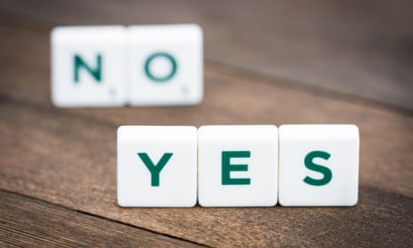 Words “yes” and “no” made from plastic alphabet blocks, stands on the wooden background.